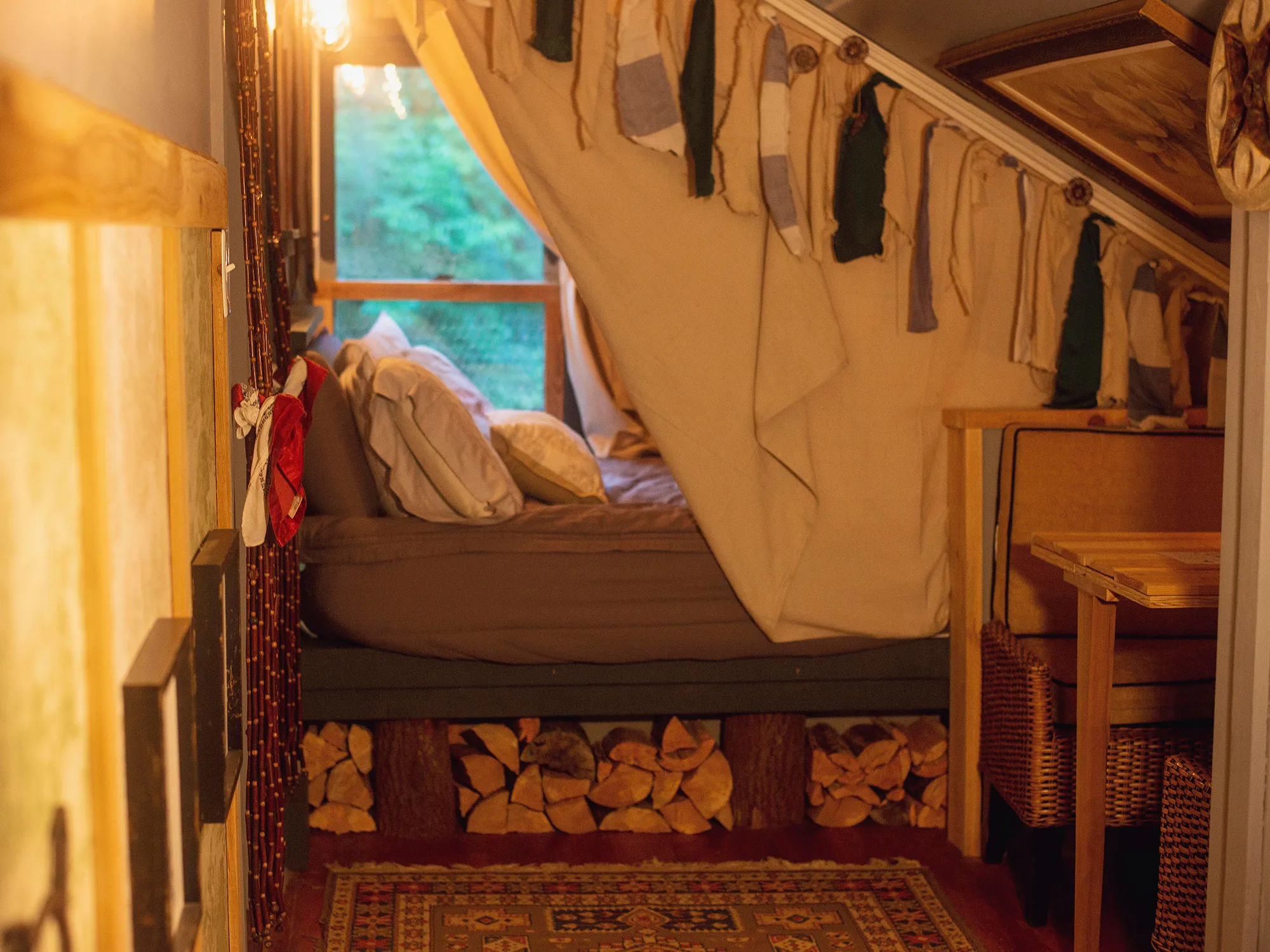 Queen bed with layered linens inside the Waterfall House